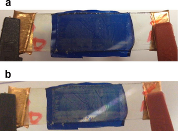 Photograph of ECD with WO3/DNA1GLY1PB2/CeO2–TiO2 configuration at (a) −2.8 V/15 s (cathodic polarization) and (b) at 1.5 V/15 s (anodic polarization).